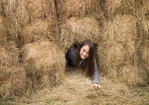 climbing in hay at the farm