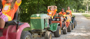 kids riding mower at farm